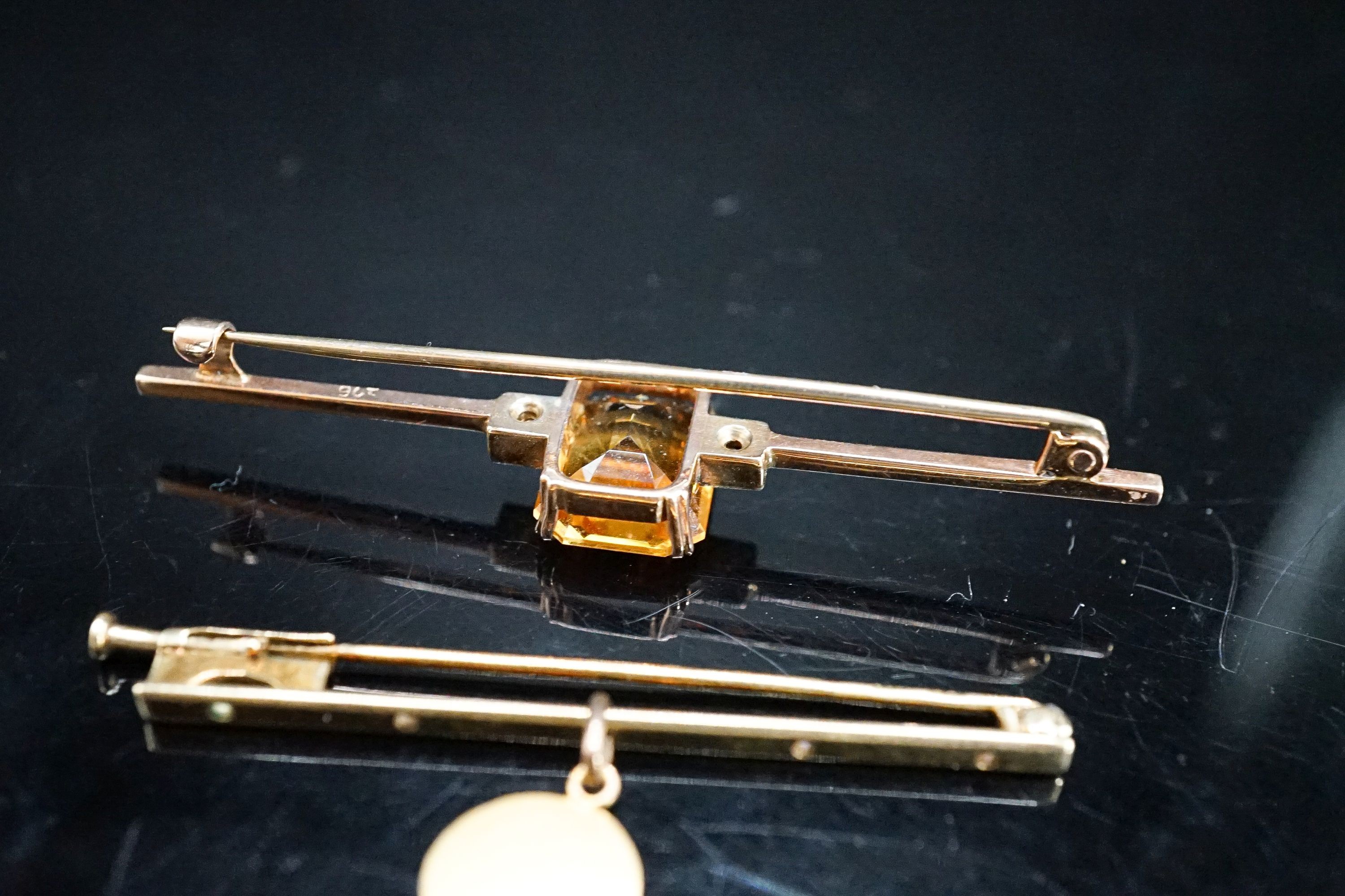 A yellow metal, single stone citrine and two stone diamond set bar brooch, 56mm and one other with cherub pendant charm, gross 6.3 grams.